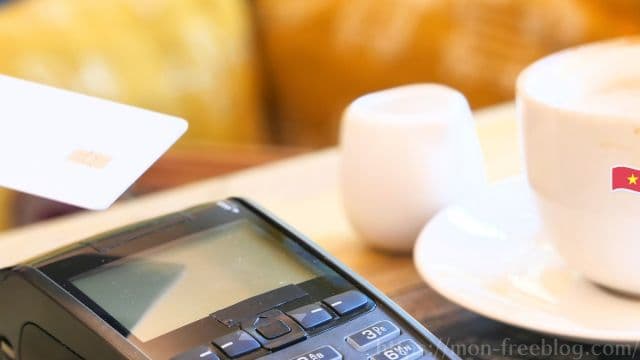 ベトナムのカフェでカードをタッチ決済するイメージ
